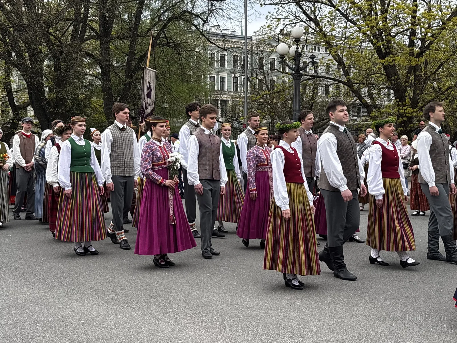 Warta honorowa Armii Łotewskiej przy Pomniku Wolności ze ścianą kwiatów ułożonych u podstawy, Ryga, w Dzień Przywrócenia Niepodległości